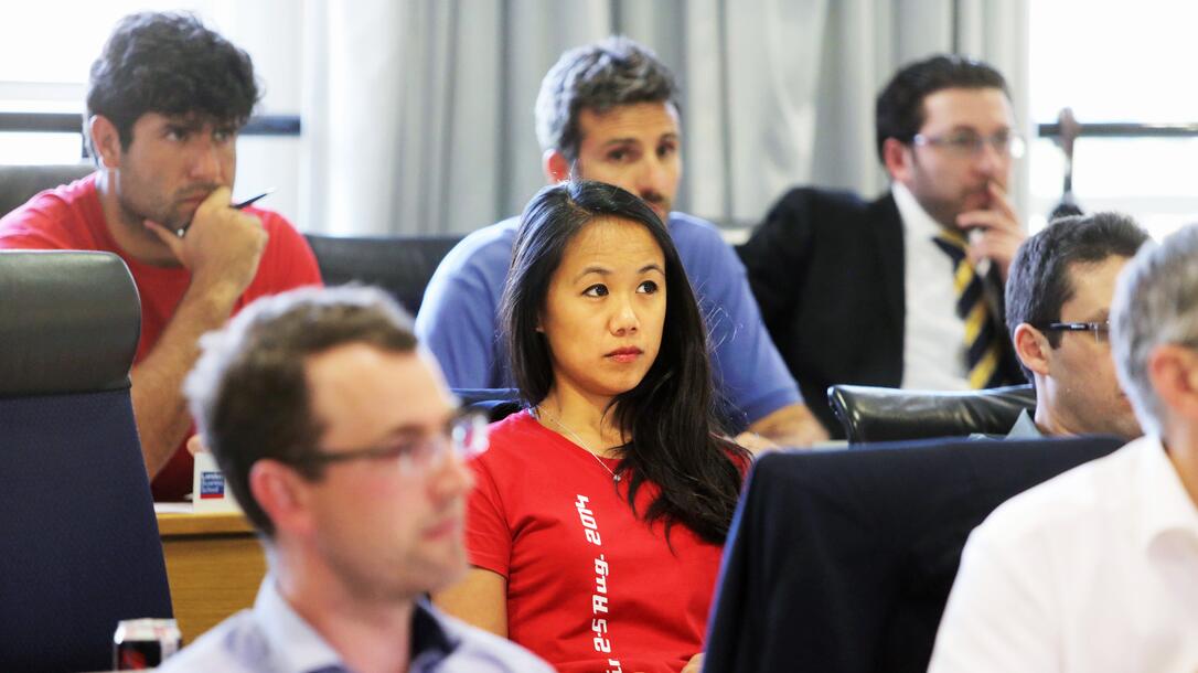 A group of EMBA students listen attentively during a core class lecture