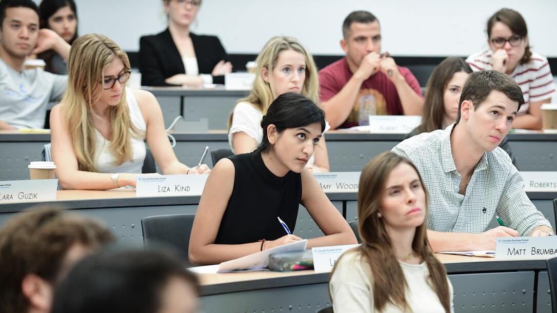 Students take notes during a class lecture
