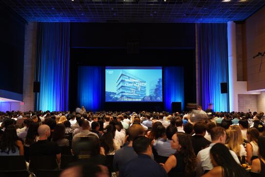 students in auditorium watching presentation