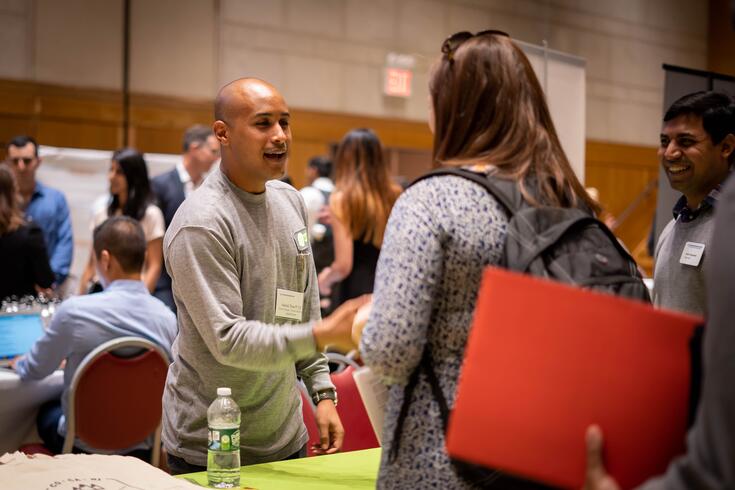 A student meets with an HR manager during a recruiting event